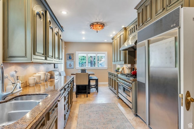 1120 E Yale Ave, Salt Lake City, UT 84105 - kitchen featuring appliances with stainless steel finishes, under cabinet range hood, recessed lighting, light stone countertops, and light tile patterned floors