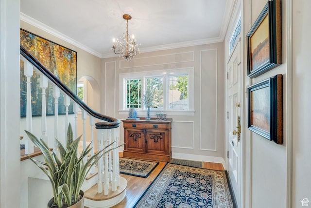 1120 E Yale Ave, Salt Lake City, UT 84105 - entrance foyer featuring stairway, a chandelier, light wood-type flooring, and crown molding