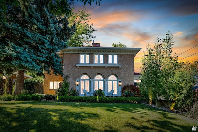 1120 E Yale Ave, Salt Lake City, UT 84105 - italianate home featuring a chimney, a lawn, and stucco siding