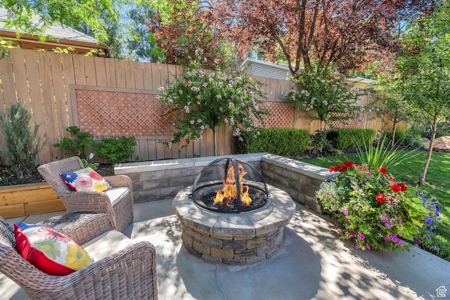 1120 E Yale Ave, Salt Lake City, UT 84105 - fenced backyard featuring an outdoor fire pit and a patio area