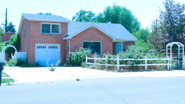 948 E 150 N, Provo, UT 84606 - view of front facade with concrete driveway, an attached garage, brick siding, and a shingled roof