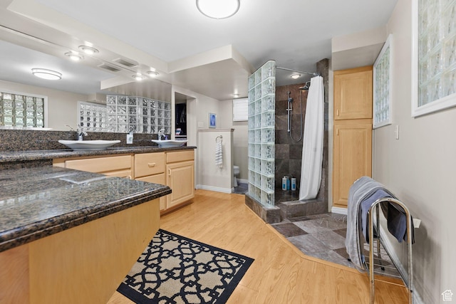 3491 S Monte Verde Dr E, Millcreek, UT 84109 - bathroom with a stall shower, wood finished floors, and double vanity