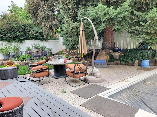 3491 S Monte Verde Dr E, Millcreek, UT 84109 - wooden deck with outdoor dining area, a fenced backyard, and a patio area