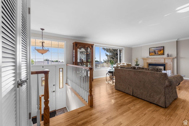3491 S Monte Verde Dr E, Millcreek, UT 84109 - living area with light wood-type flooring, crown molding, and a fireplace