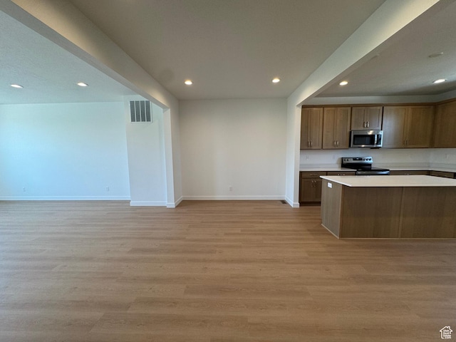 1464 N 1875 W Unit 149, Layton, UT 84041 - kitchen featuring stainless steel microwave, range with electric stovetop, recessed lighting, light wood-style floors, and light countertops