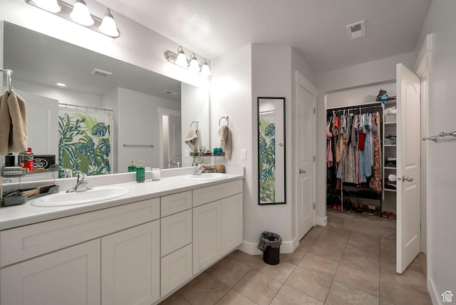 3781 W 2330 N, Lehi, UT 84043 - bathroom with double vanity, a walk in closet, and tile patterned floors