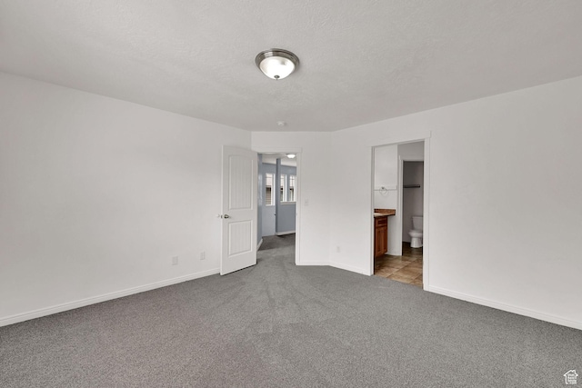 1568 N 565 W Unit 104, Logan, UT 84341 - unfurnished bedroom with carpet flooring, a textured ceiling, and connected bathroom