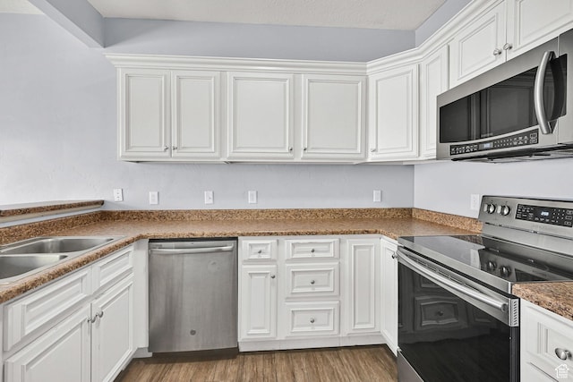 1568 N 565 W Unit 104, Logan, UT 84341 - kitchen with stainless steel appliances, white cabinets, and wood finished floors