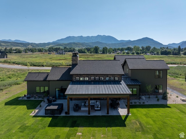 322 S 7900th St E Unit 5, Huntsville, UT 84317 - rear view of house featuring a patio, a mountain view, a yard, a chimney, and a metal roof