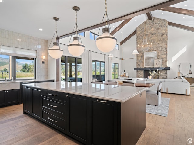 322 S 7900th St E Unit 5, Huntsville, UT 84317 - kitchen featuring dark cabinets, beam ceiling, a large island, light wood-style floors, and high vaulted ceiling