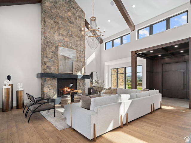 322 S 7900th St E Unit 5, Huntsville, UT 84317 - living room featuring high vaulted ceiling, beam ceiling, light wood finished floors, a stone fireplace, and a chandelier