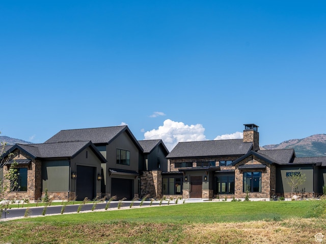 322 S 7900th St E Unit 5, Huntsville, UT 84317 - view of front facade featuring stone siding, a front lawn, a mountain view, a chimney, and a shingled roof