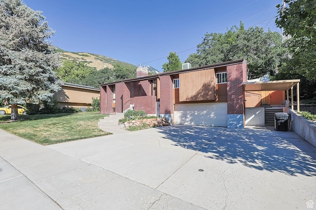3574 E Kings Cove Way, Cottonwood Heights, UT 84121 - view of front of property with a front lawn, a garage, driveway, and brick siding