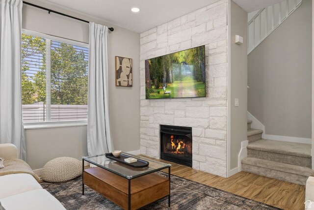 3584 S Autumn Gate Ct, Magna, UT 84044 - living area featuring plenty of natural light, a fireplace, wood finished floors, stairs, and recessed lighting