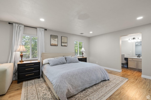 3584 S Autumn Gate Ct, Magna, UT 84044 - bedroom featuring light wood finished floors, recessed lighting, and connected bathroom