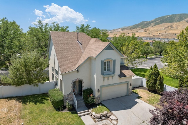 3584 S Autumn Gate Ct, Magna, UT 84044 - view of front of home with roof with shingles, stucco siding, stone siding, driveway, and an attached garage
