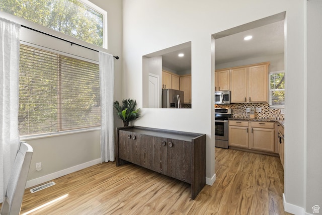 3584 S Autumn Gate Ct, Magna, UT 84044 - kitchen featuring appliances with stainless steel finishes, light wood finished floors, light brown cabinetry, backsplash, and recessed lighting