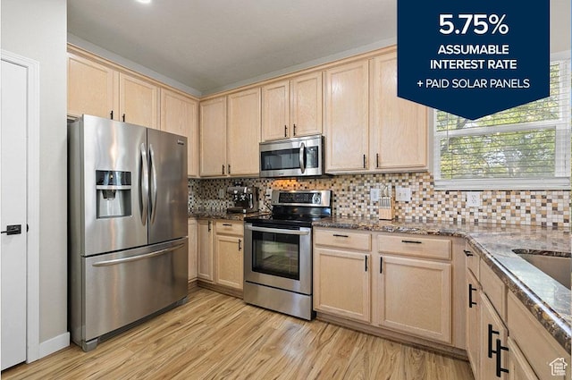 3584 S Autumn Gate Ct, Magna, UT 84044 - kitchen featuring stainless steel appliances, light brown cabinetry, light wood-type flooring, and dark stone counters
