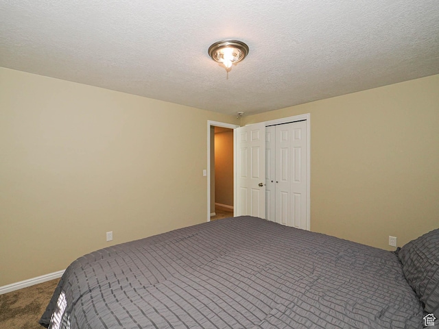 1473 E Millcreek Way, Millcreek, UT 84106 - carpeted bedroom featuring a closet and a textured ceiling