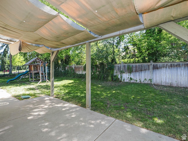 1473 E Millcreek Way, Millcreek, UT 84106 - fenced backyard featuring a playground and a patio