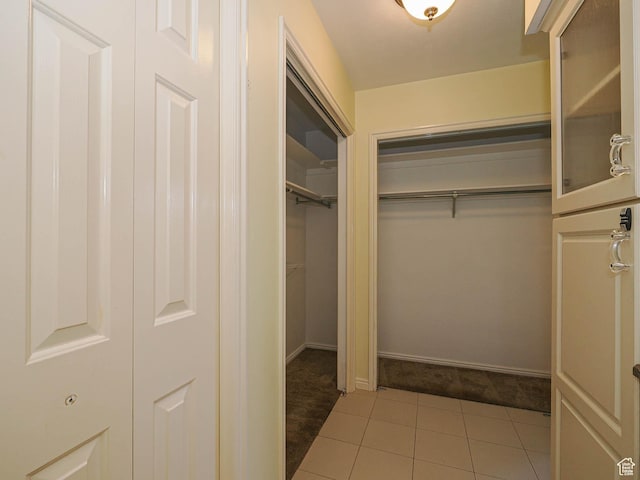 1473 E Millcreek Way, Millcreek, UT 84106 - walk in closet featuring tile patterned floors and carpet floors