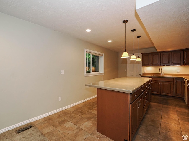 1473 E Millcreek Way, Millcreek, UT 84106 - kitchen featuring light countertops, a center island, decorative light fixtures, recessed lighting, and a textured ceiling