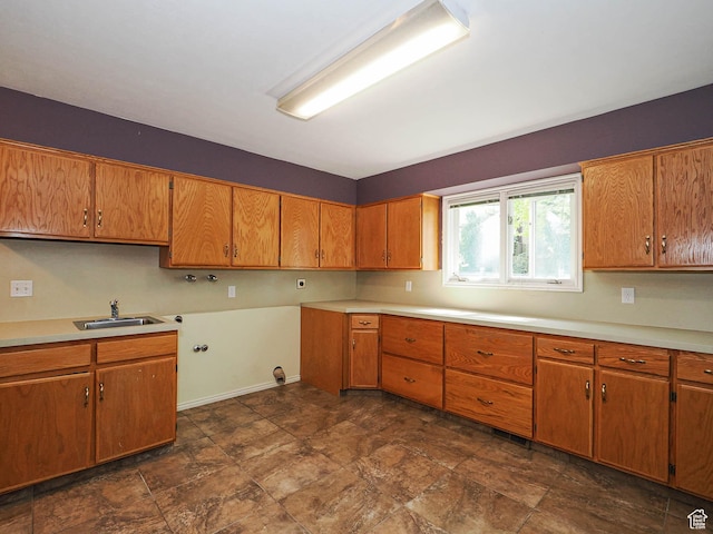 1473 E Millcreek Way, Millcreek, UT 84106 - kitchen with brown cabinets, light countertops, and stone finish floors