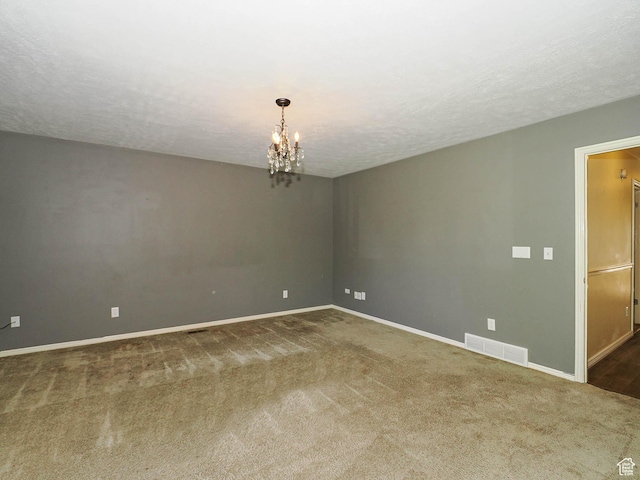 1473 E Millcreek Way, Millcreek, UT 84106 - carpeted empty room featuring a chandelier and a textured ceiling