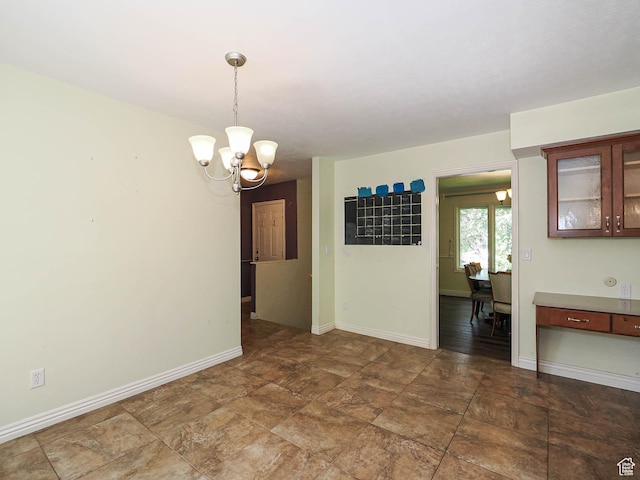 1473 E Millcreek Way, Millcreek, UT 84106 - empty room featuring a chandelier and stone finish floors