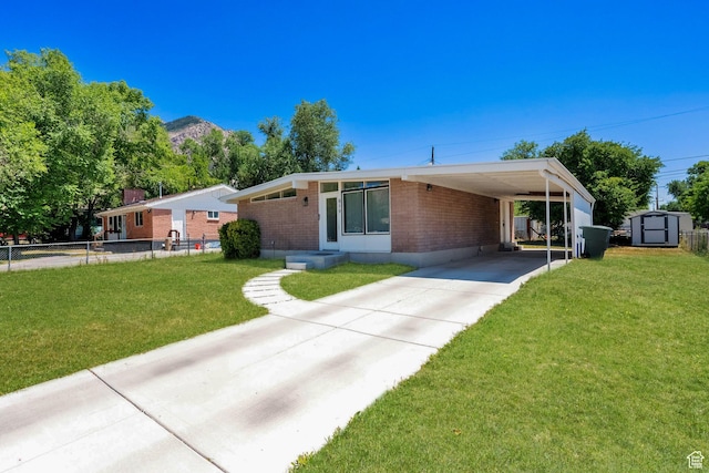 819 E 1100 N, Ogden, UT 84404 - view of front of home featuring a storage unit, brick siding, concrete driveway, and a carport