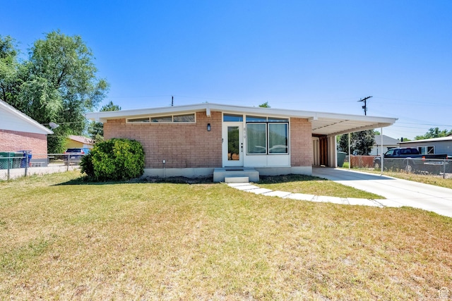 819 E 1100 N, Ogden, UT 84404 - mid-century home featuring an attached carport, entry steps, concrete driveway, and brick siding