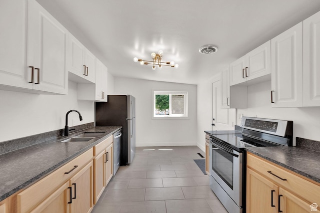 819 E 1100 N, Ogden, UT 84404 - kitchen with appliances with stainless steel finishes, a chandelier, light tile patterned floors, and light brown cabinetry