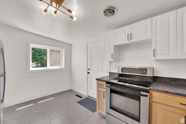 819 E 1100 N, Ogden, UT 84404 - kitchen with electric range, dark countertops, and white cabinetry