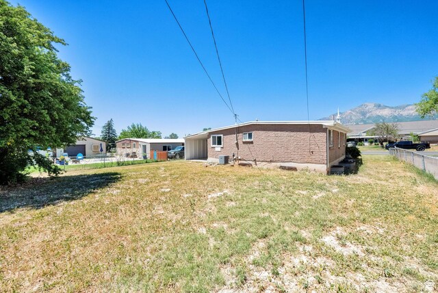 819 E 1100 N, Ogden, UT 84404 - rear view of house with brick siding and a mountain view