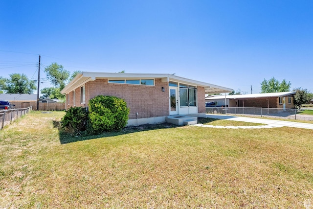 819 E 1100 N, Ogden, UT 84404 - rear view of house with brick siding and a carport