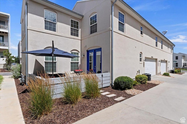 10606 S Redknife Dr, South Jordan, UT 84009 - view of front facade featuring a garage, driveway, and stucco siding