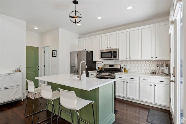 10606 S Redknife Dr, South Jordan, UT 84009 - kitchen featuring appliances with stainless steel finishes, dark wood finished floors, white cabinets, and recessed lighting