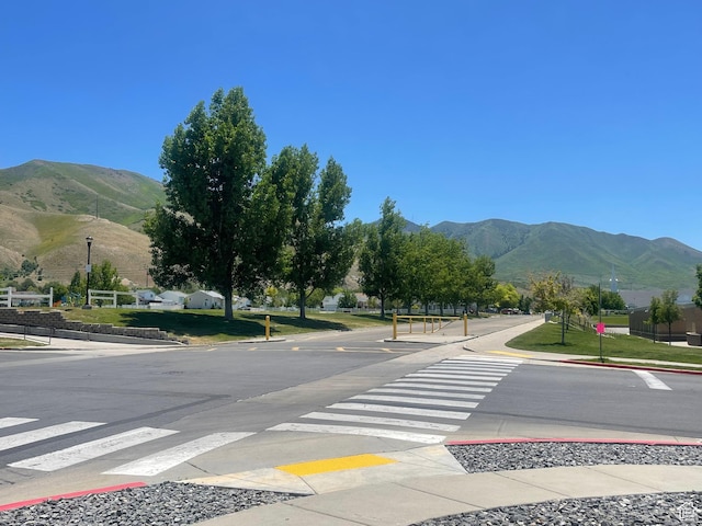 908 W Timpie Rd S, Tooele, UT 84074 - view of asphalt street with a mountain view, curbs, sidewalks, and street lights