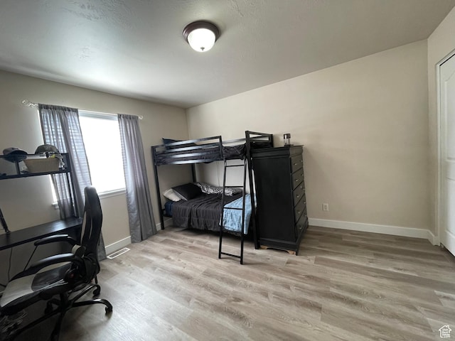 908 W Timpie Rd S, Tooele, UT 84074 - bedroom with light wood-style floors and an office area