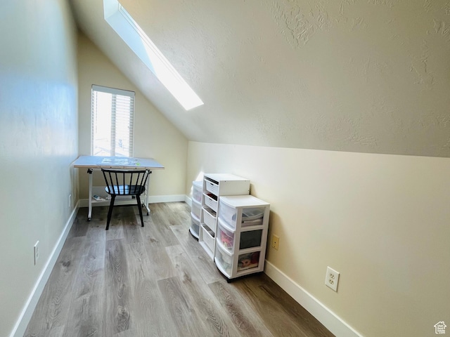 908 W Timpie Rd S, Tooele, UT 84074 - bonus room with a skylight, vaulted ceiling, wood finished floors, and a textured ceiling