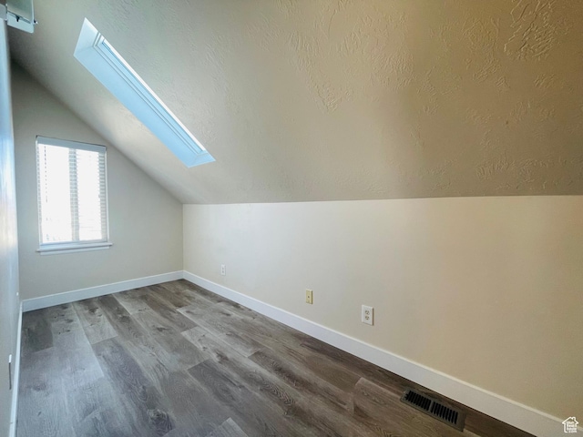 908 W Timpie Rd S, Tooele, UT 84074 - bonus room featuring a skylight, lofted ceiling, and wood finished floors