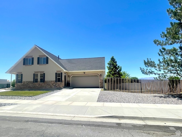 908 W Timpie Rd S, Tooele, UT 84074 - view of front of property featuring stucco siding, a garage, concrete driveway, and stone siding