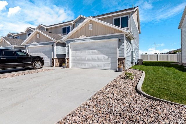 48 E Cedar Ln, Malad City, ID 83252 - view of front of house with board and batten siding, driveway, an attached garage, and stone siding