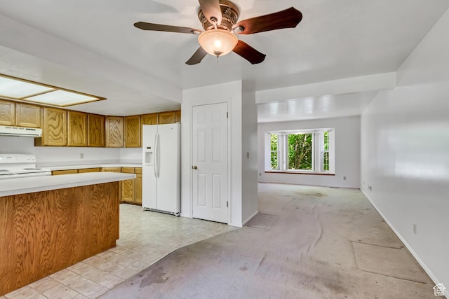 2386 N 725 W, Layton, UT 84041 - kitchen featuring white appliances, under cabinet range hood, brown cabinets, light countertops, and light carpet