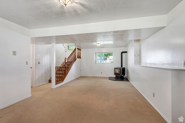 2386 N 725 W, Layton, UT 84041 - basement featuring stairway, a wood stove, and carpet floors
