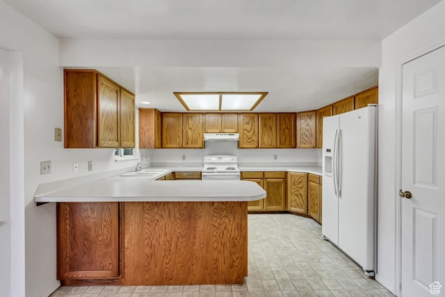 2386 N 725 W, Layton, UT 84041 - kitchen featuring white appliances, under cabinet range hood, light countertops, a peninsula, and brown cabinets