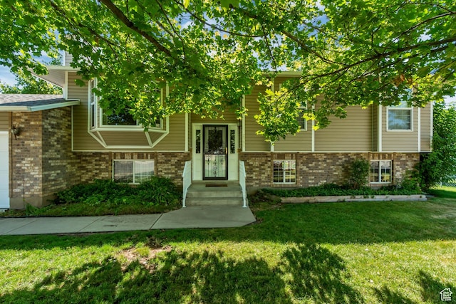 2386 N 725 W, Layton, UT 84041 - split foyer home with brick siding, a front yard, and a garage