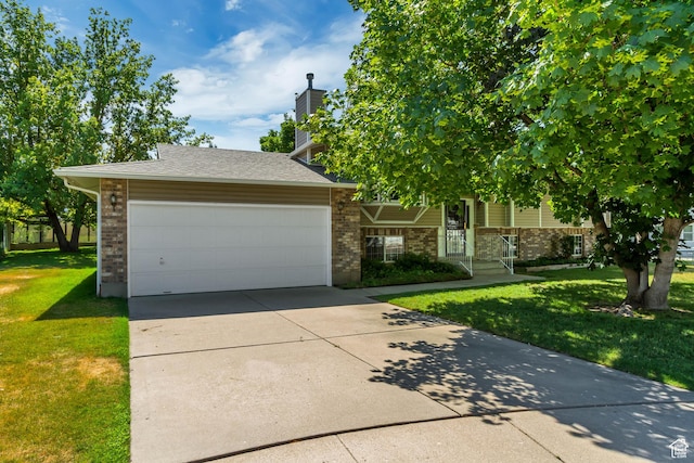 2386 N 725 W, Layton, UT 84041 - view of property hidden behind natural elements with a front lawn, brick siding, driveway, an attached garage, and a chimney