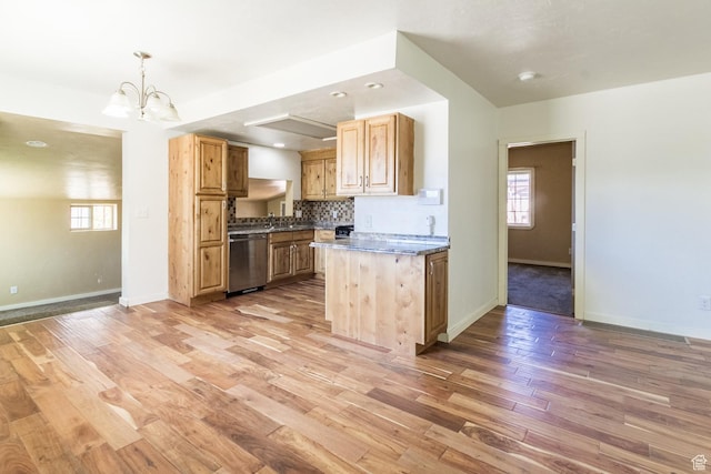 168 S 100 W, Roosevelt, UT 84066 - kitchen with stainless steel dishwasher, light wood-style flooring, a chandelier, backsplash, and dark countertops