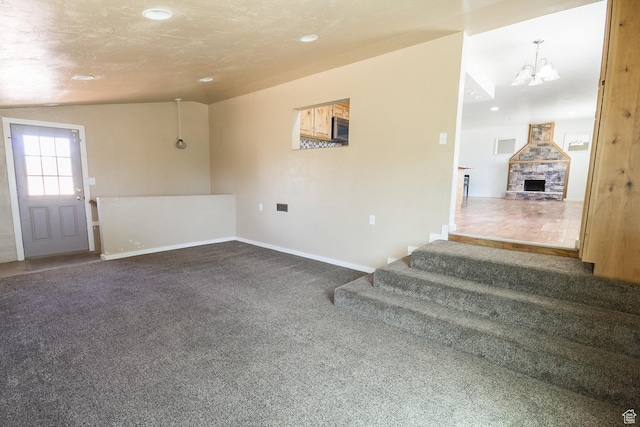 168 S 100 W, Roosevelt, UT 84066 - foyer entrance featuring a chandelier, recessed lighting, dark colored carpet, a stone fireplace, and stairs